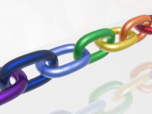 Chain with color links, white reflective background.